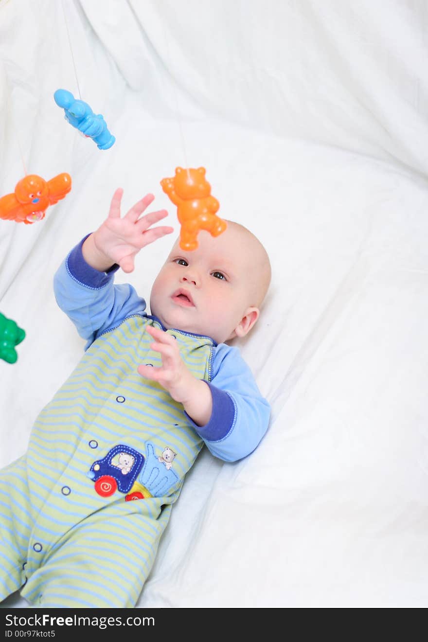 Baby playing with toys. Little boy touching the toys by finger