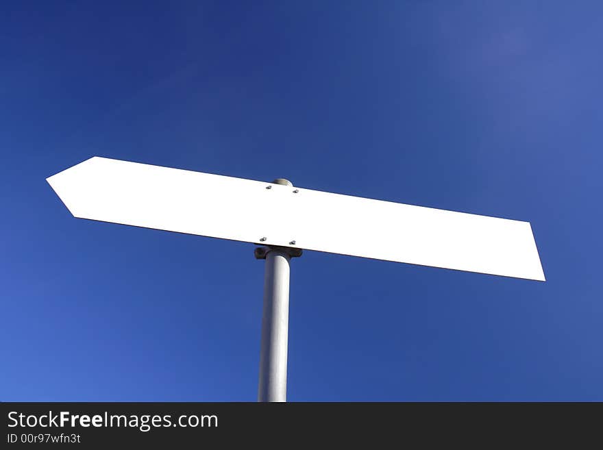 Blank white direction board with blue sky in the background