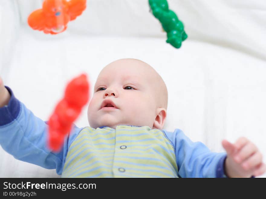 Baby playing with toys. Little boy touching the toys by finger