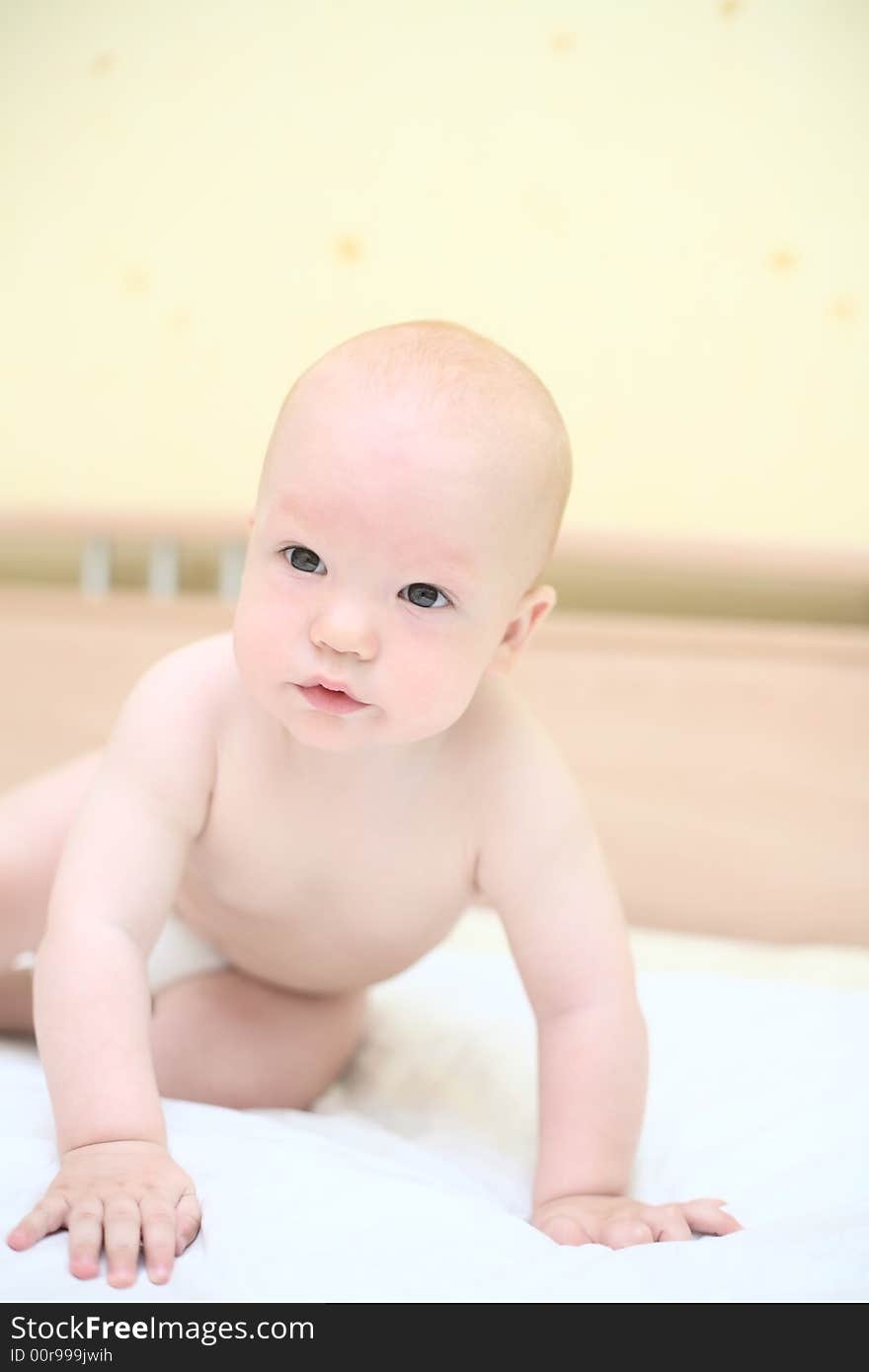 Toddler crawling on bed #1. Toddler crawling on bed #1