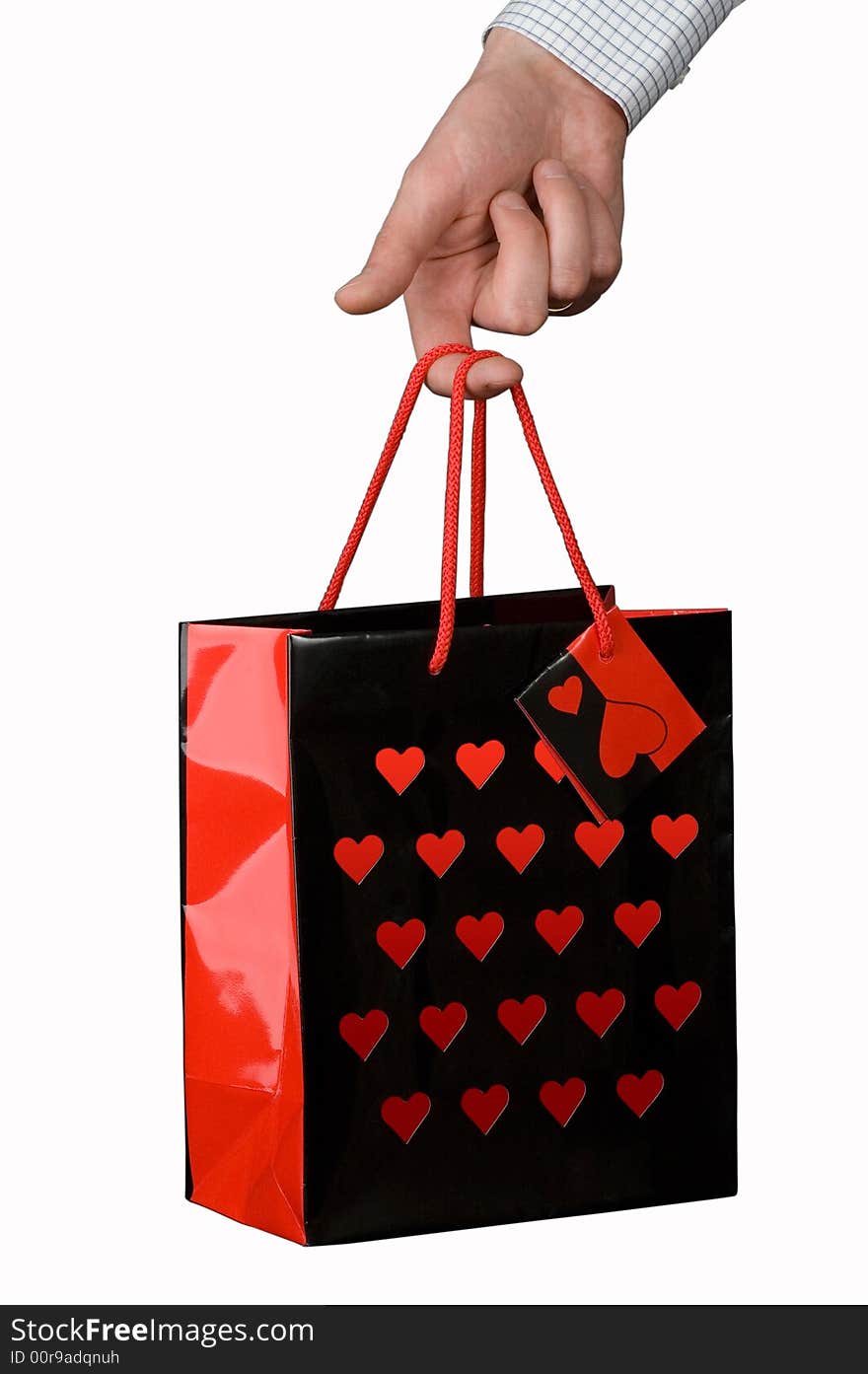 Gift bag in hand on white background. Gift bag in hand on white background