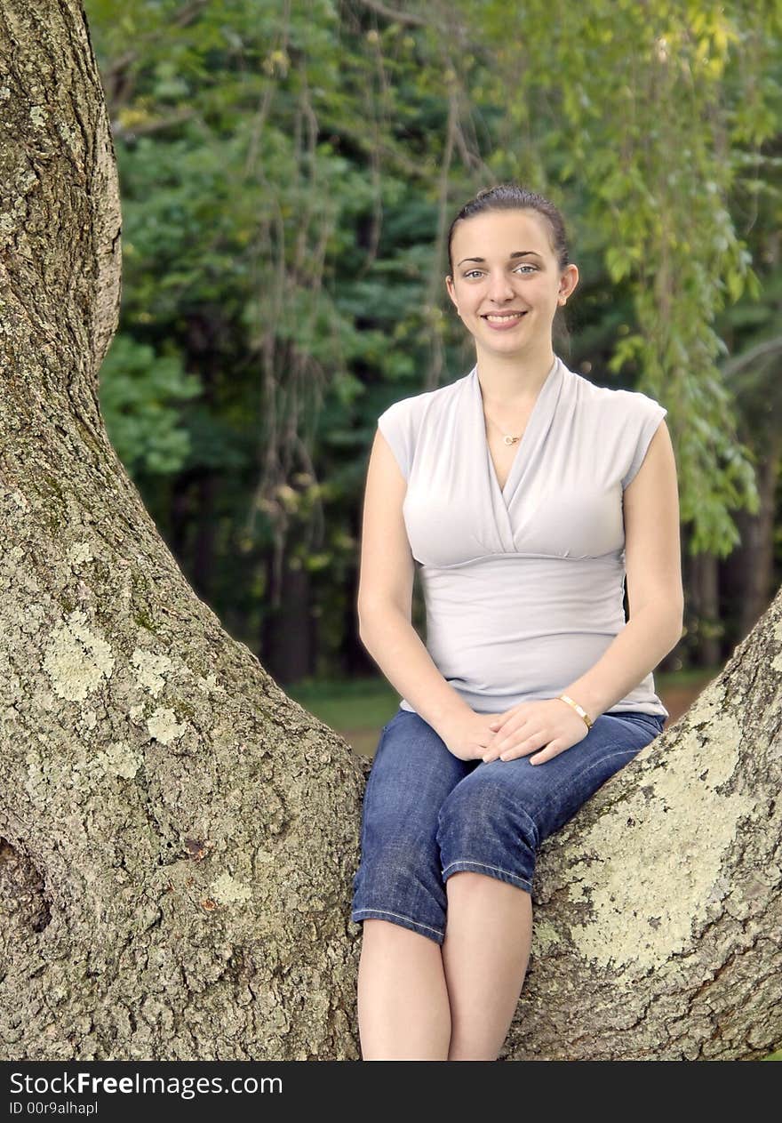 Girl sitting in a big tree. Girl sitting in a big tree