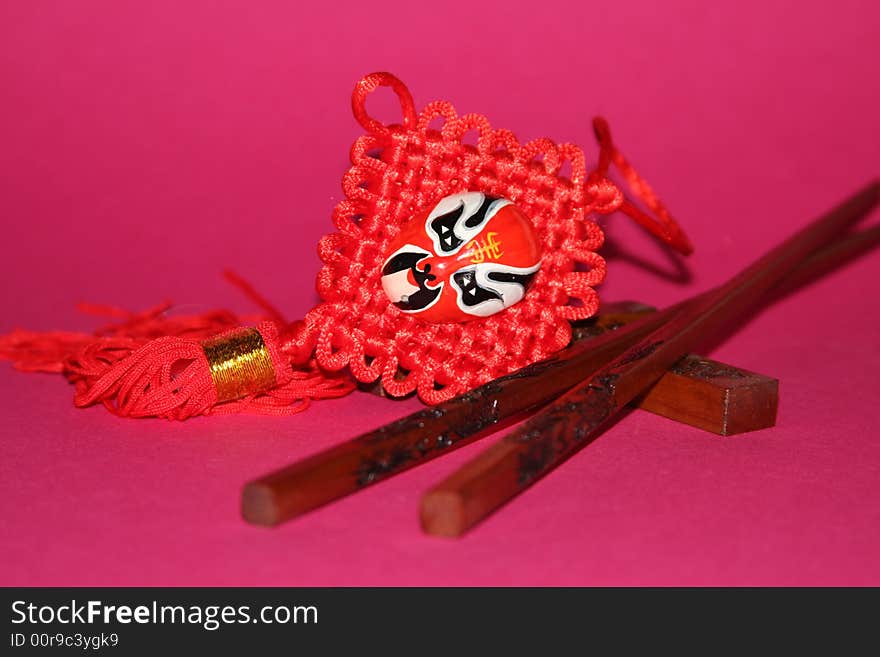 It is a Chinese traditional objects for food and decoration on a red background. It is a Chinese traditional objects for food and decoration on a red background