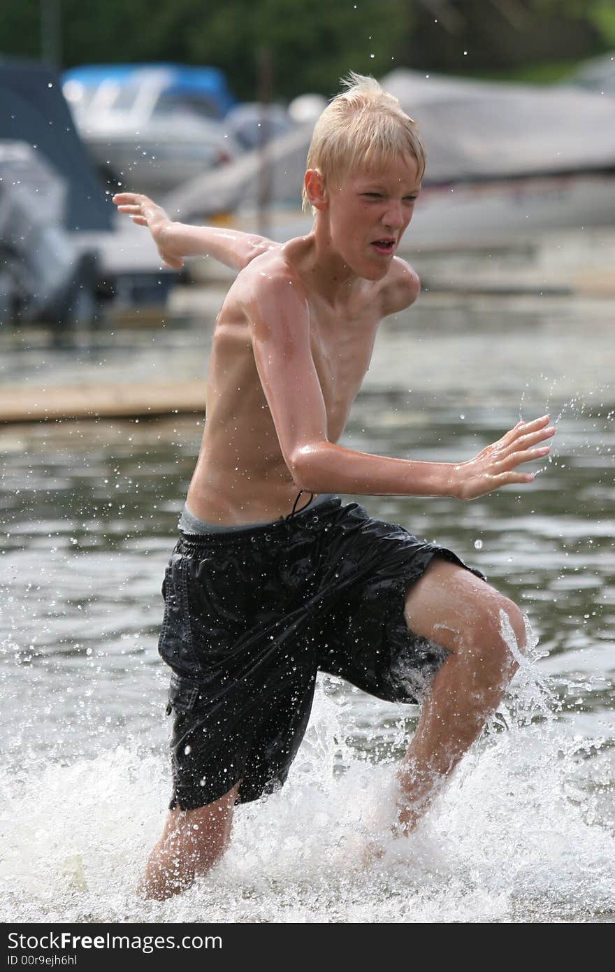 Boy running in shallow water. Boy running in shallow water