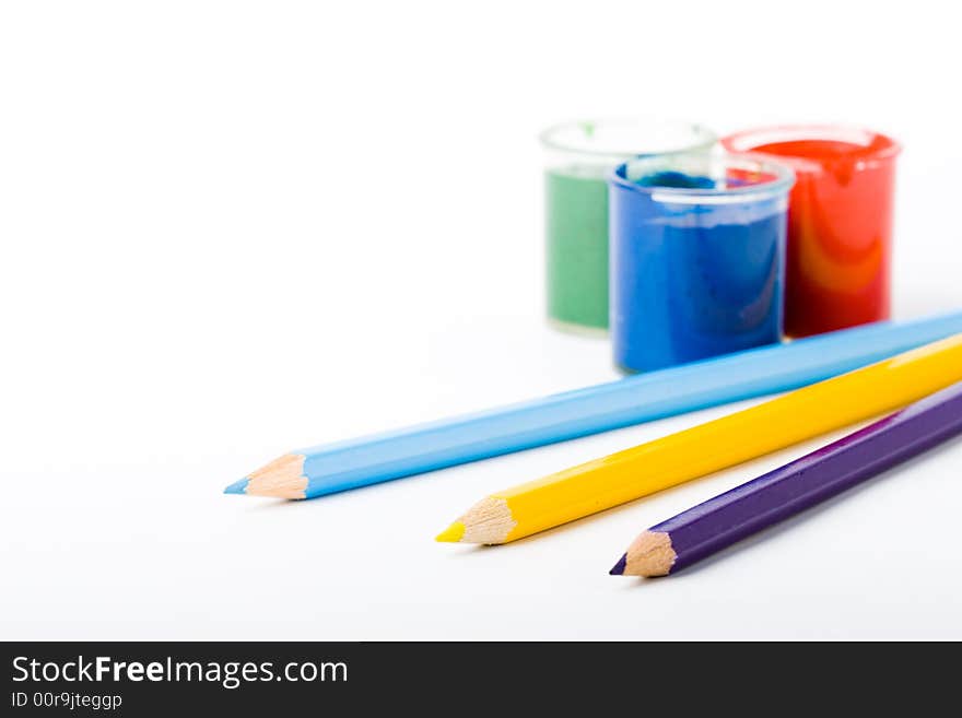 Three jars with gouache and pencils. Three jars with gouache and pencils