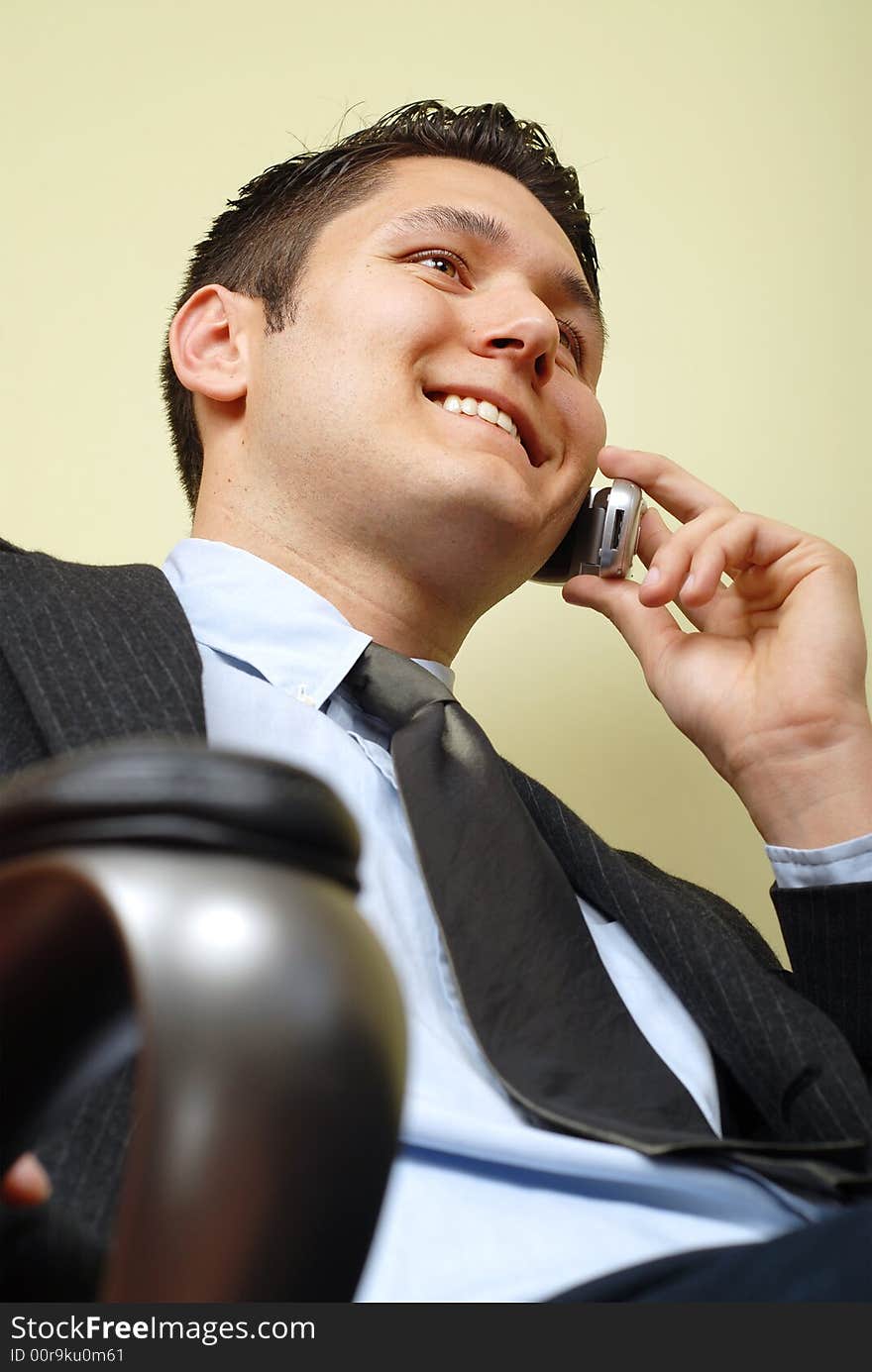 Handsome businessman sitting in his chair at the office. Handsome businessman sitting in his chair at the office