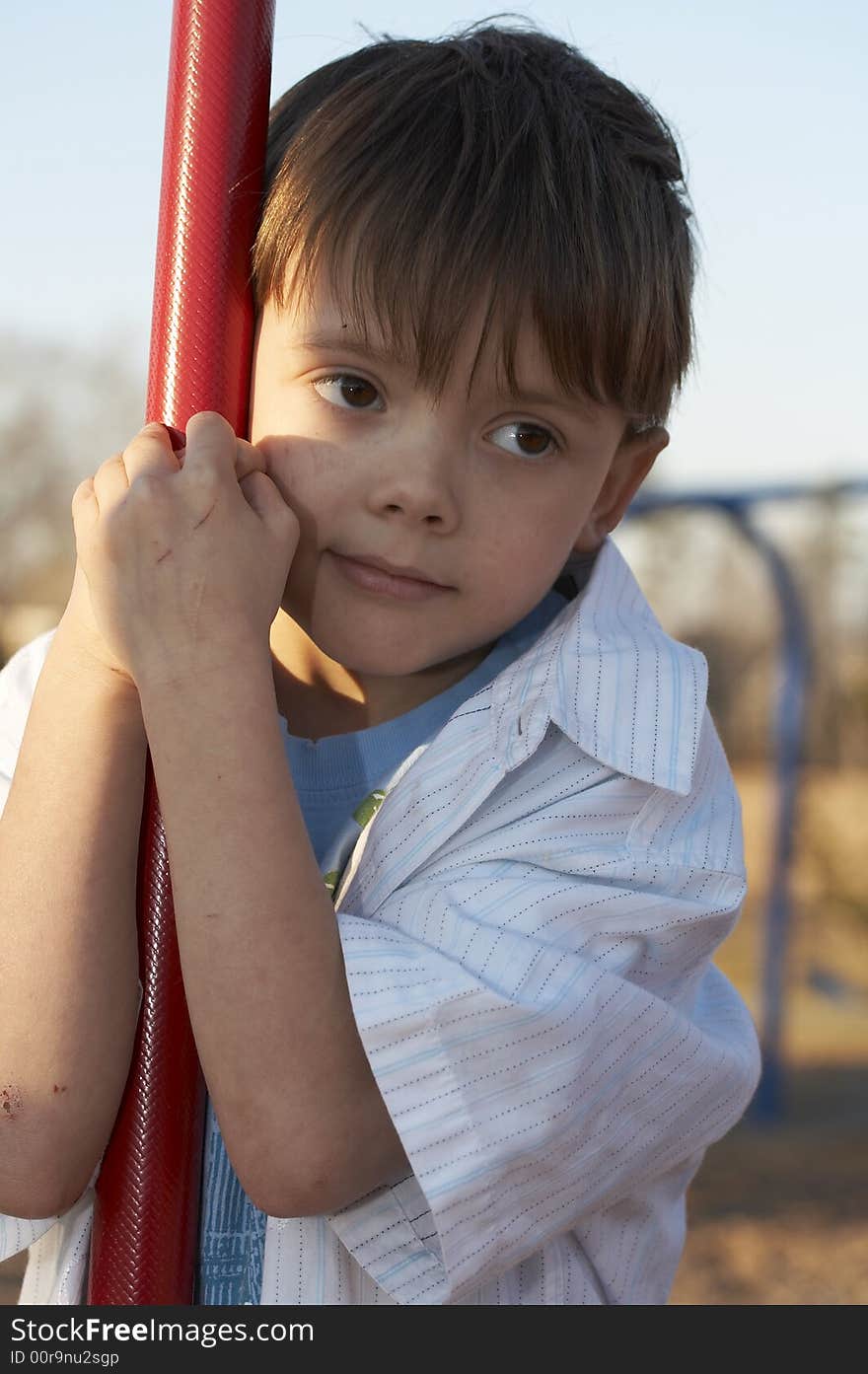 A young boy playing on play ground equipment. A young boy playing on play ground equipment