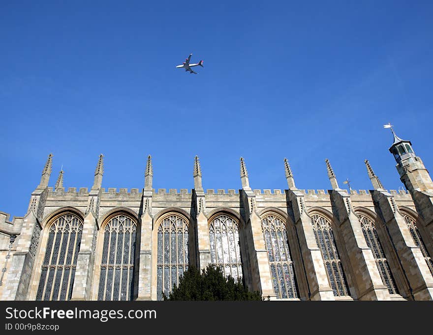 Medieval Eton College Chapel in England against a clear blue Winter Sky with a plane flying overhead