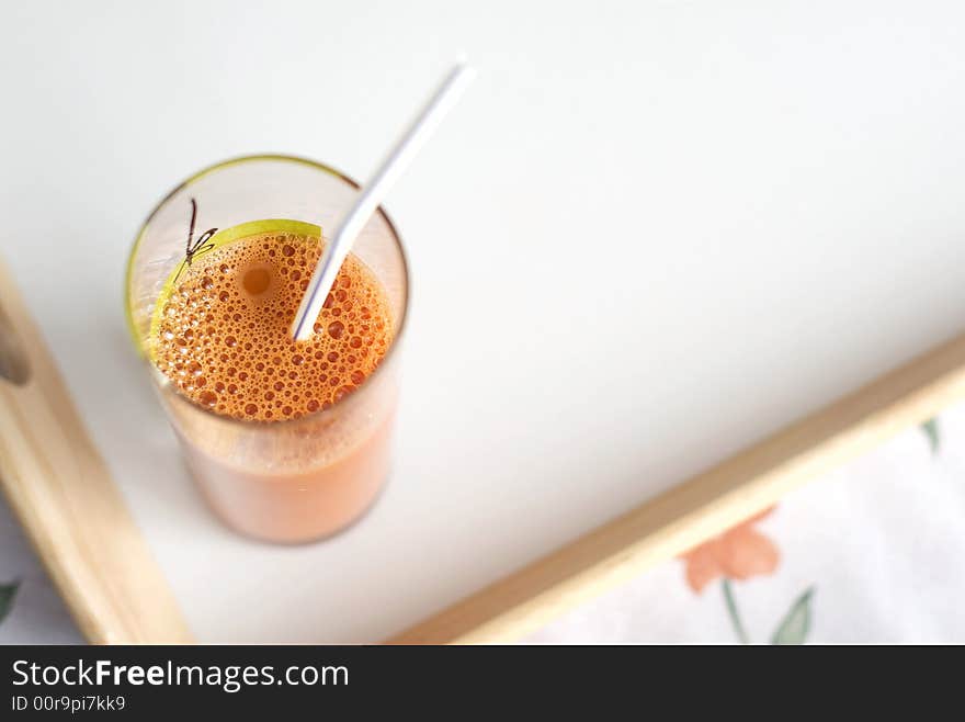 Carrots  fresh juice in a glass with sipper