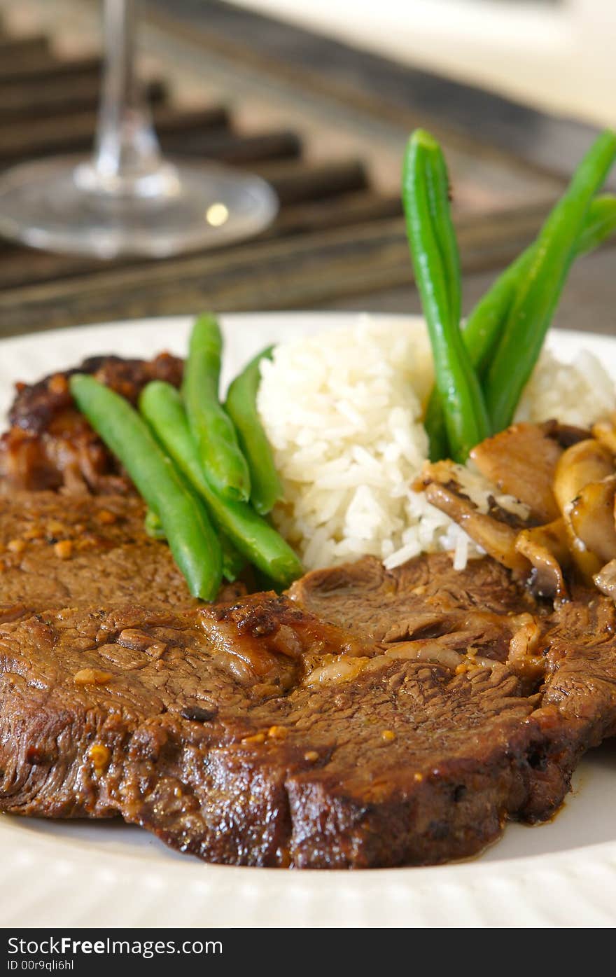 Cooked Ribeye meal rice green beans and mushrooms close up. Cooked Ribeye meal rice green beans and mushrooms close up