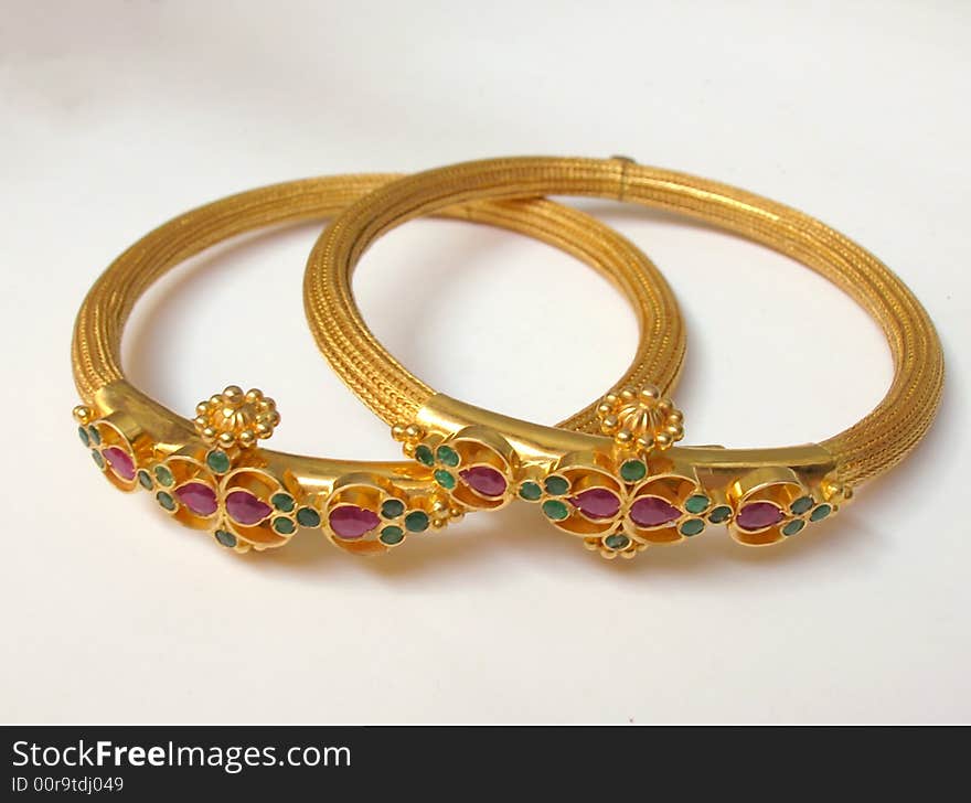 A close up of Two Gold Bangles on white