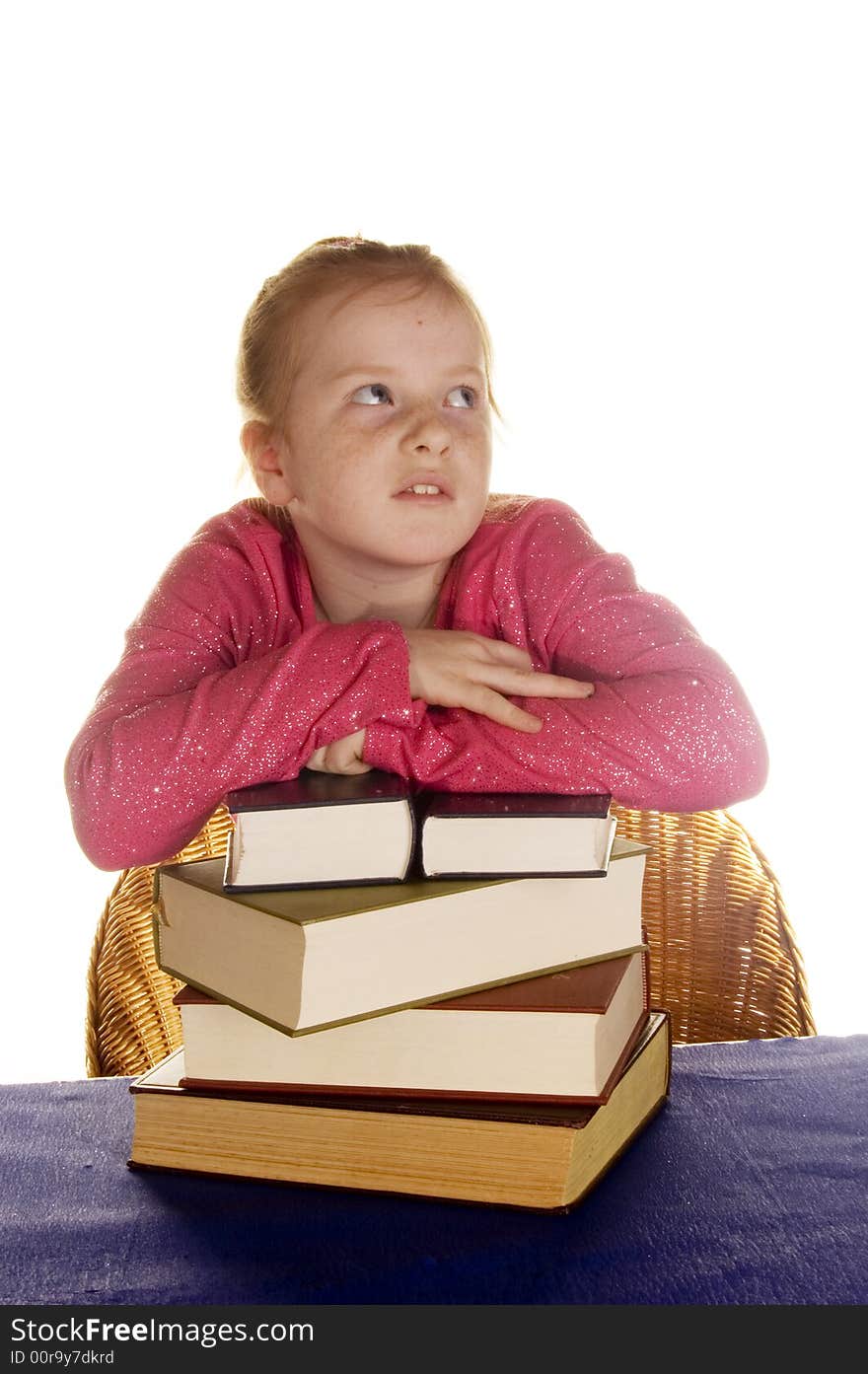 Young little girl above a stock of books