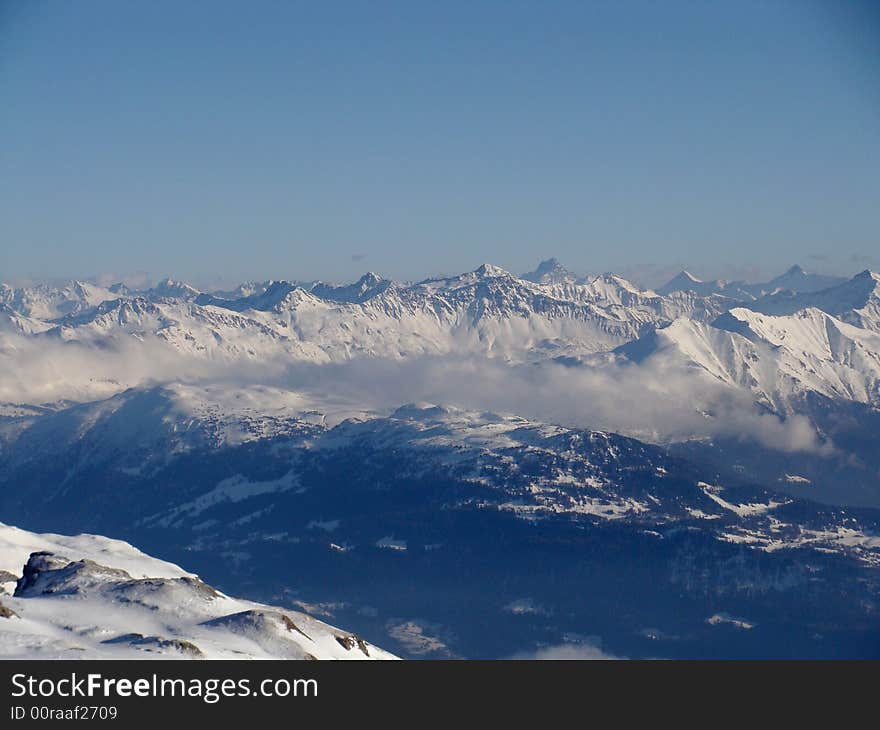 Fog in the valleys between many high peaks, eastern Switzerland.