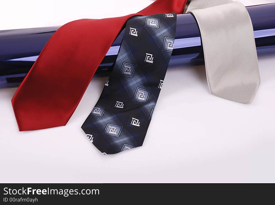 Ties over dark blue pipe on white background