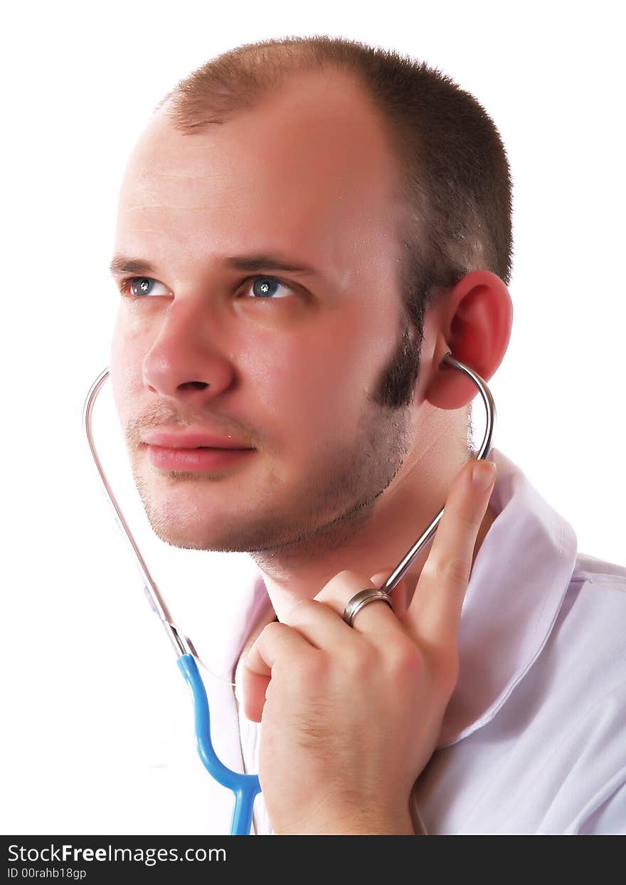 Young doctor using a stethoscope and smiling. Young doctor using a stethoscope and smiling