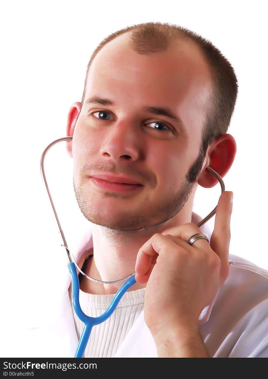 Young doctor using a stethoscope and smiling. Young doctor using a stethoscope and smiling