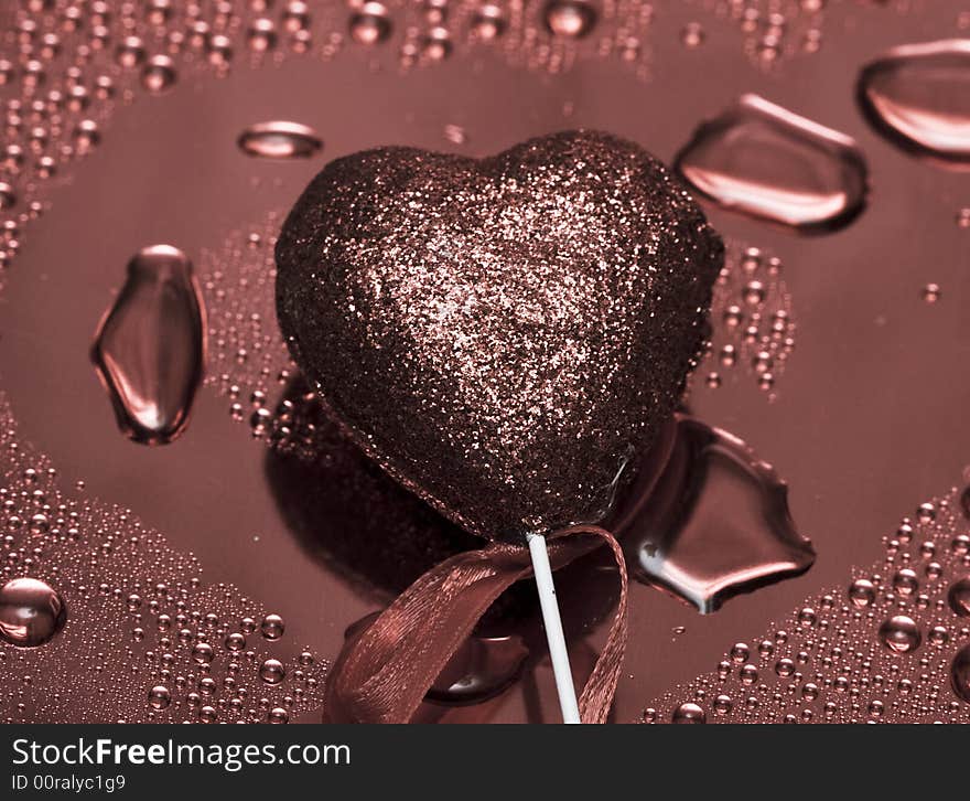 Holidays card, heart on background with water droplets