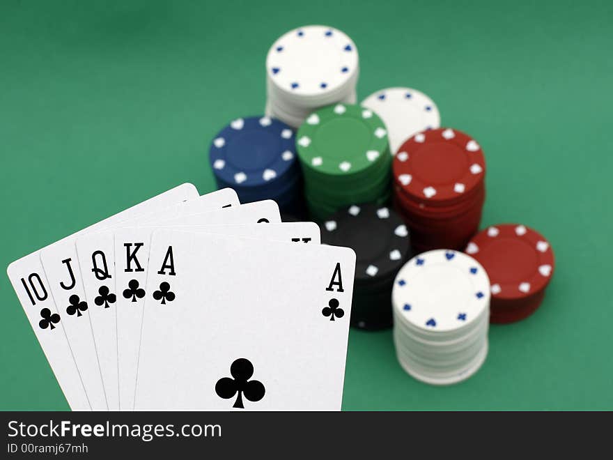 Poker playing cards royal flush with chips on green background. Poker playing cards royal flush with chips on green background