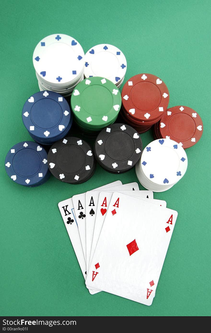 Poker playing cards four aces with chips on green background