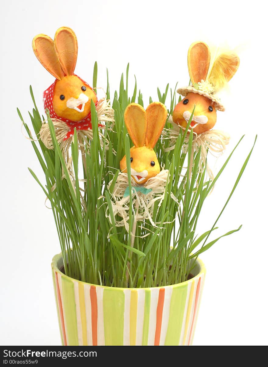 Easter rabbit family in a grass in colorful pot