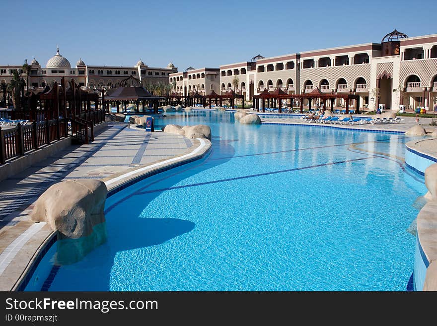 Swimming pool with bright blue water in oriental resort