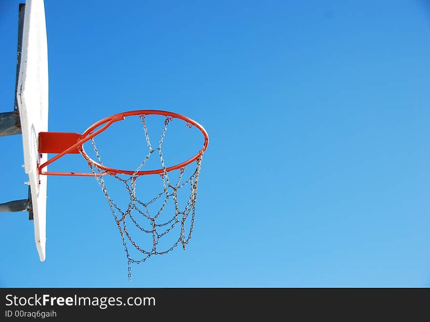 Beautiful shot of a basket ball net agains the blue sky