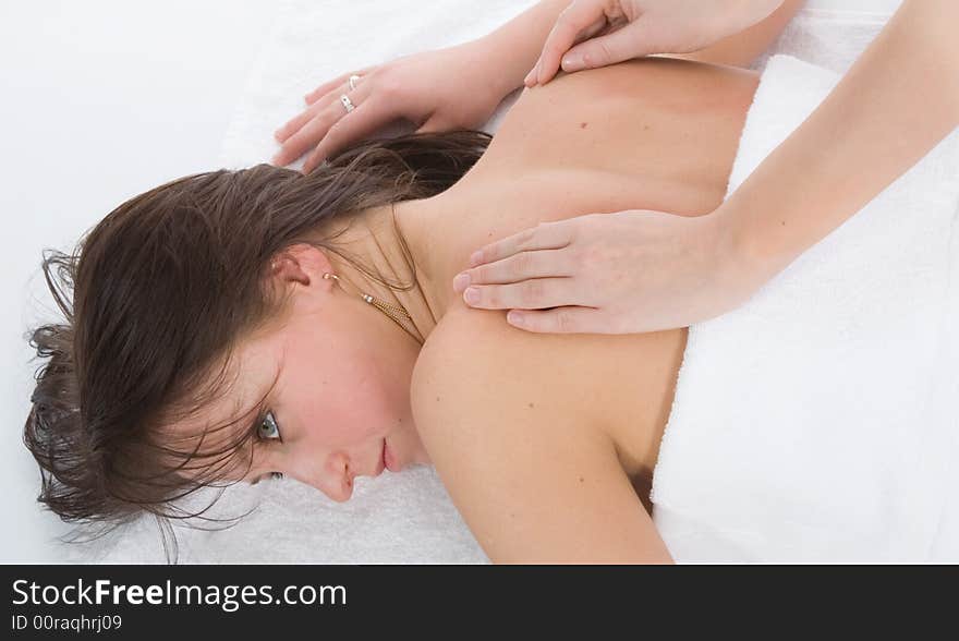 Pampered young woman with male hands doing a massage. Pampered young woman with male hands doing a massage