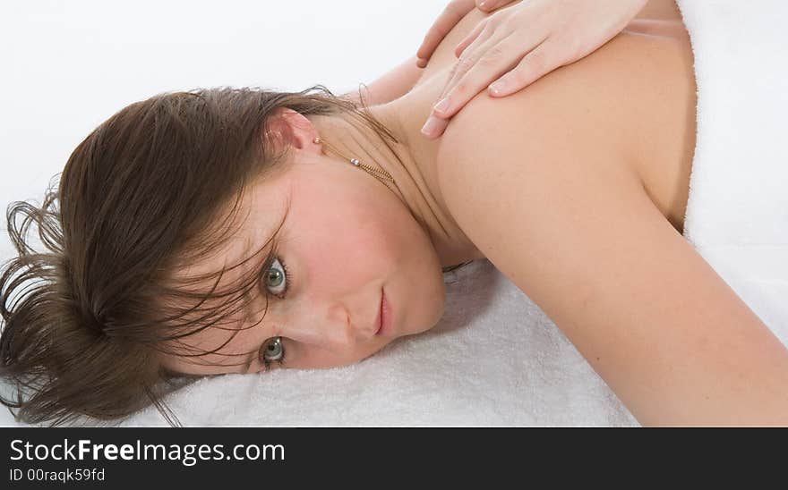 Pampered young woman with male hands doing a massage. Pampered young woman with male hands doing a massage