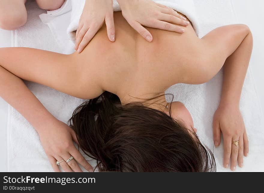 Pampered young woman with male hands doing a massage. Pampered young woman with male hands doing a massage