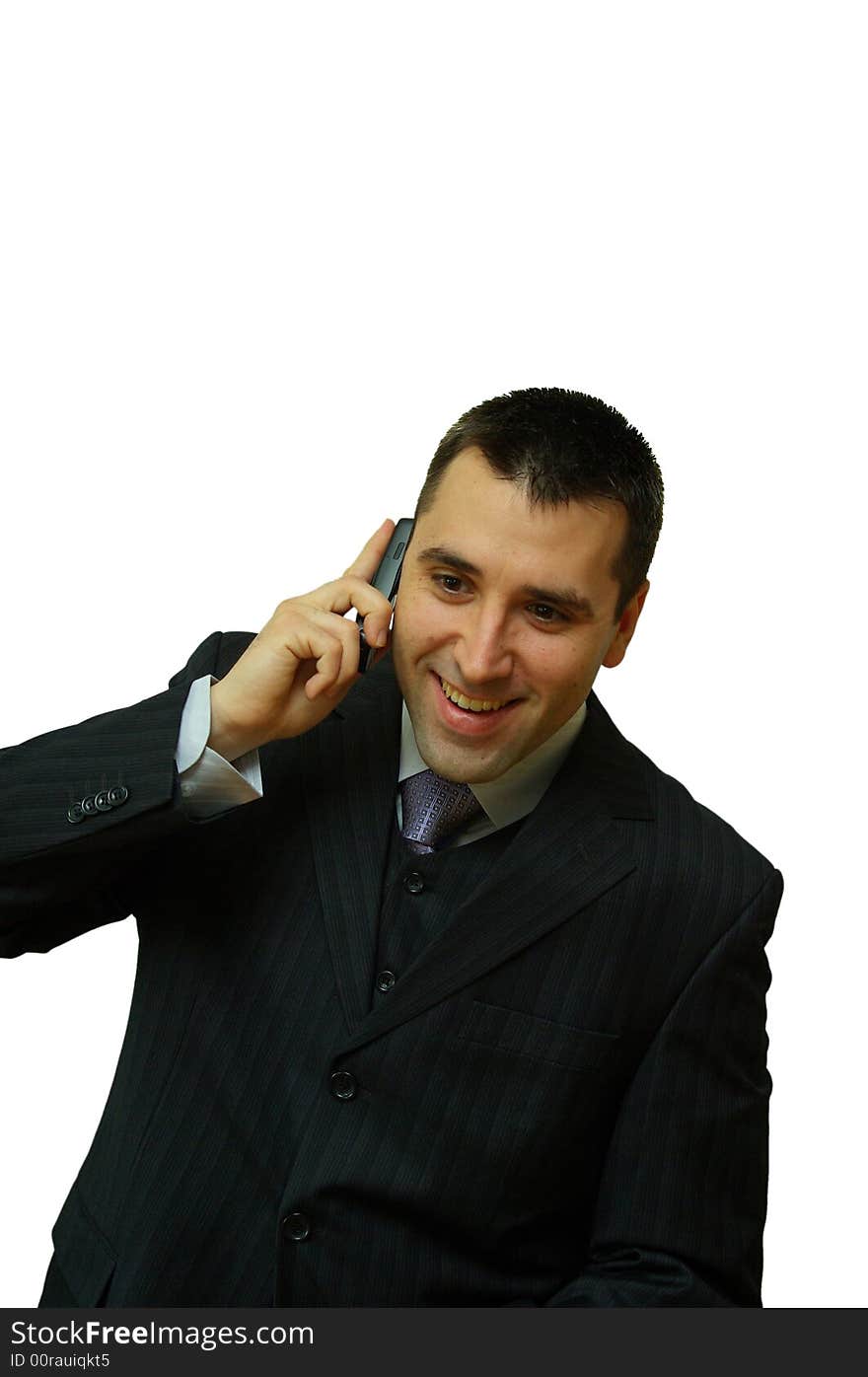 A man, holding a cellular phone in his hands, looking very happy while talking. A man, holding a cellular phone in his hands, looking very happy while talking