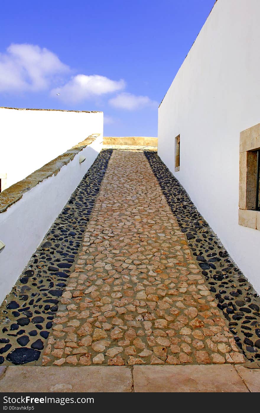 Portugal, area of Algarve, Lagos: typical military architecture. small white and black stones pavement for this typical portuguese fortress