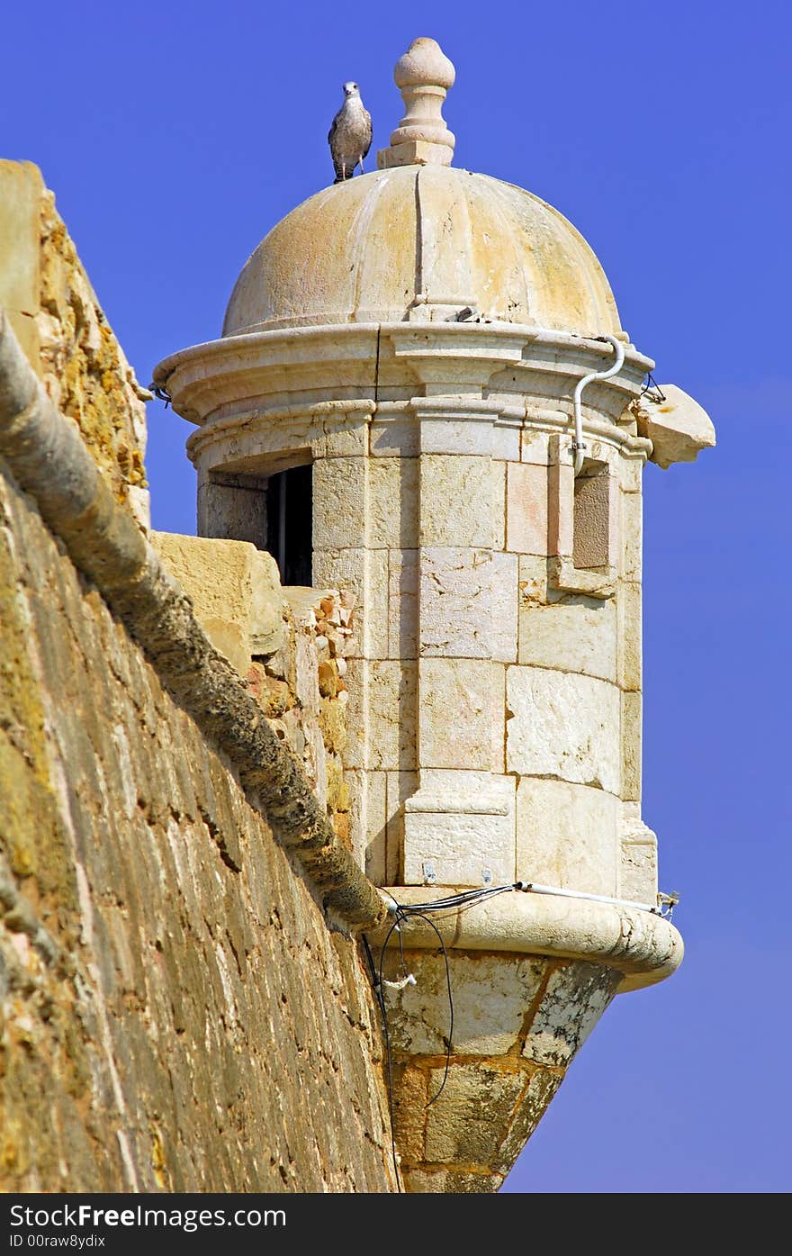 Portugal, area of Algarve, Lagos: typical military architecture, Fortress; white crow's nest with seagull on the domes top. Portugal, area of Algarve, Lagos: typical military architecture, Fortress; white crow's nest with seagull on the domes top