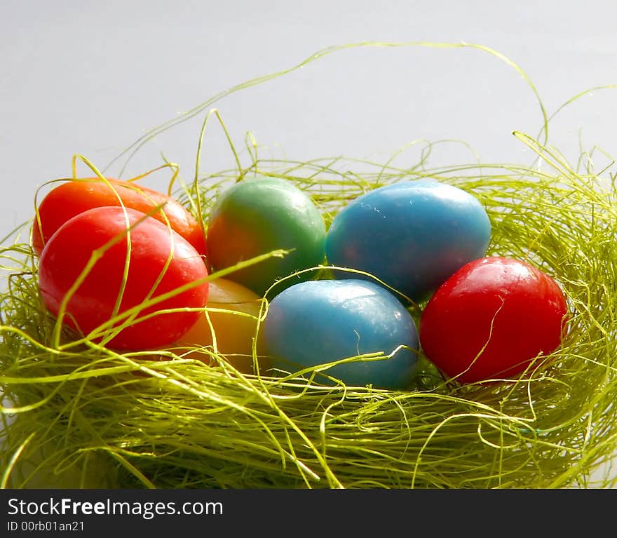 Colorful small Easter eggs in nest