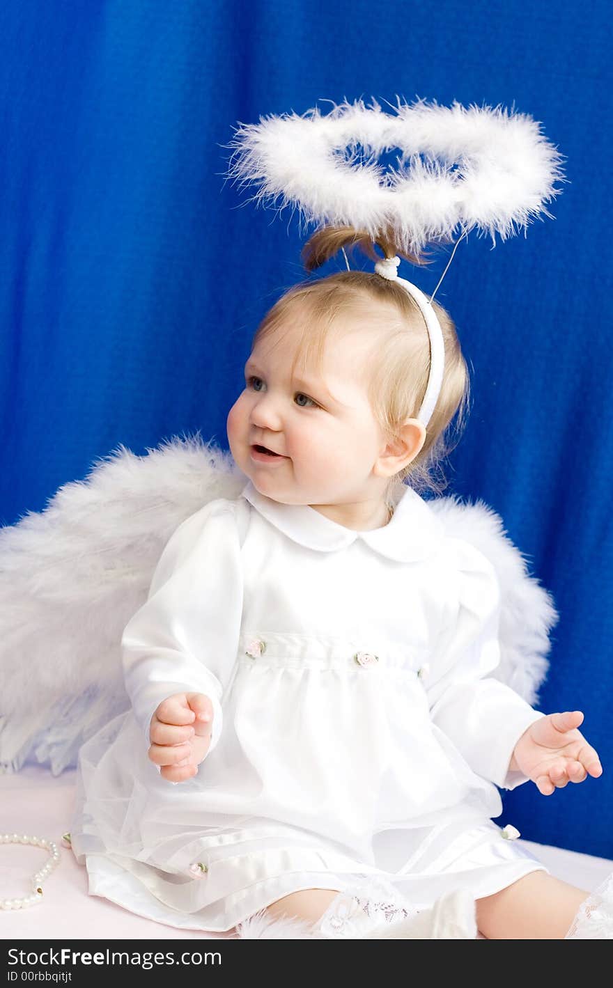 Girl angel in white clothes and with wings on a dark blue background