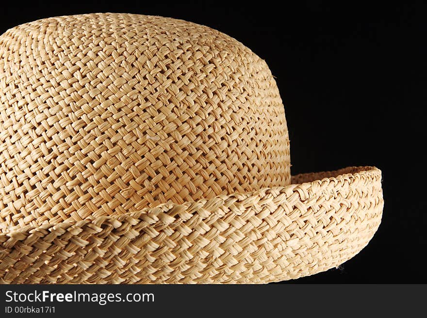 Straw summer hat over a black background. Straw summer hat over a black background