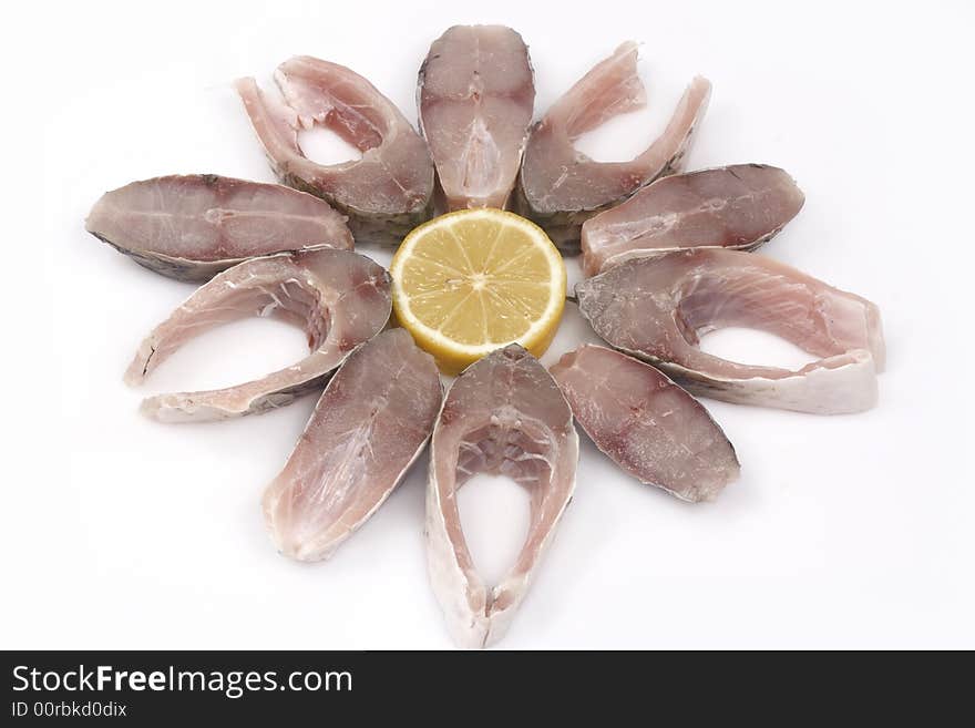 Slices of fish and lemon isolated on white background