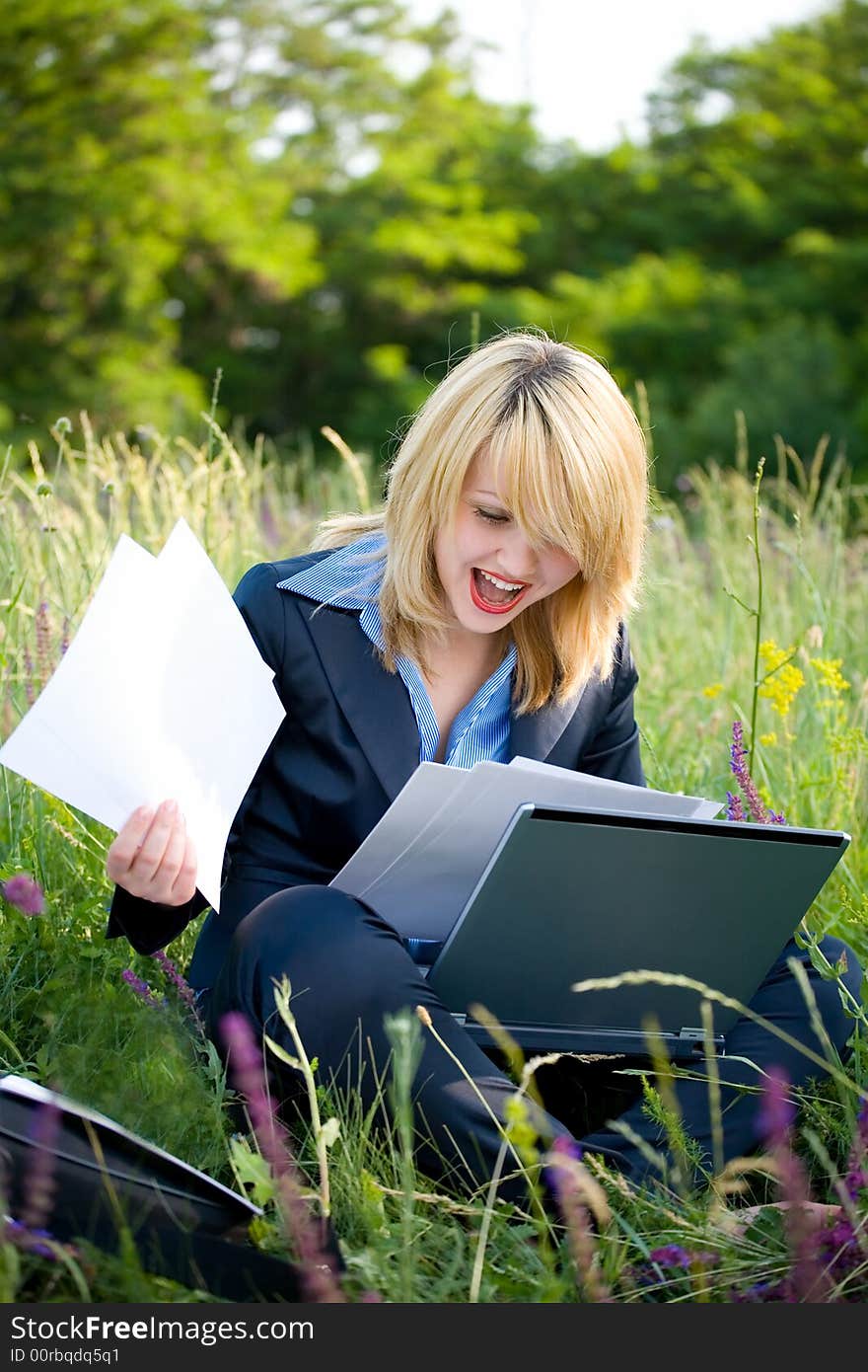 Happiness woman on grass with documents