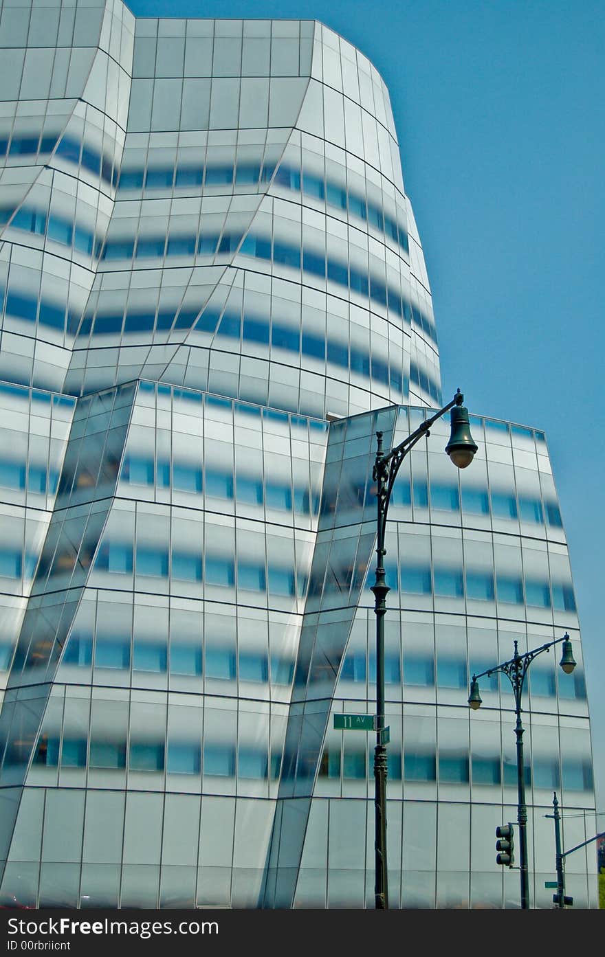 Elegant curves of a space-age office building contrast with old-world lampposts from a previous era. Elegant curves of a space-age office building contrast with old-world lampposts from a previous era.