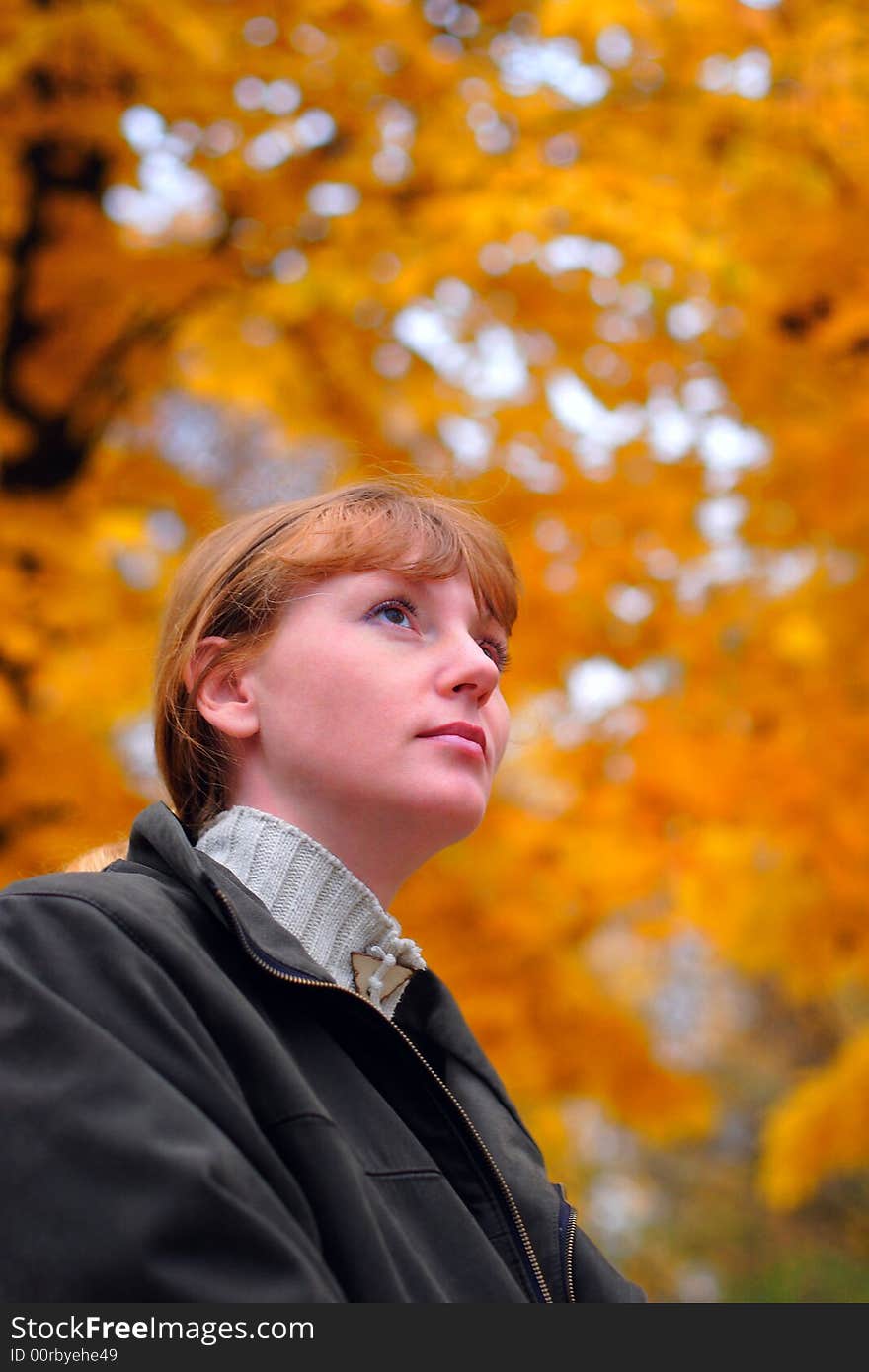 Woman look forward in autumn park