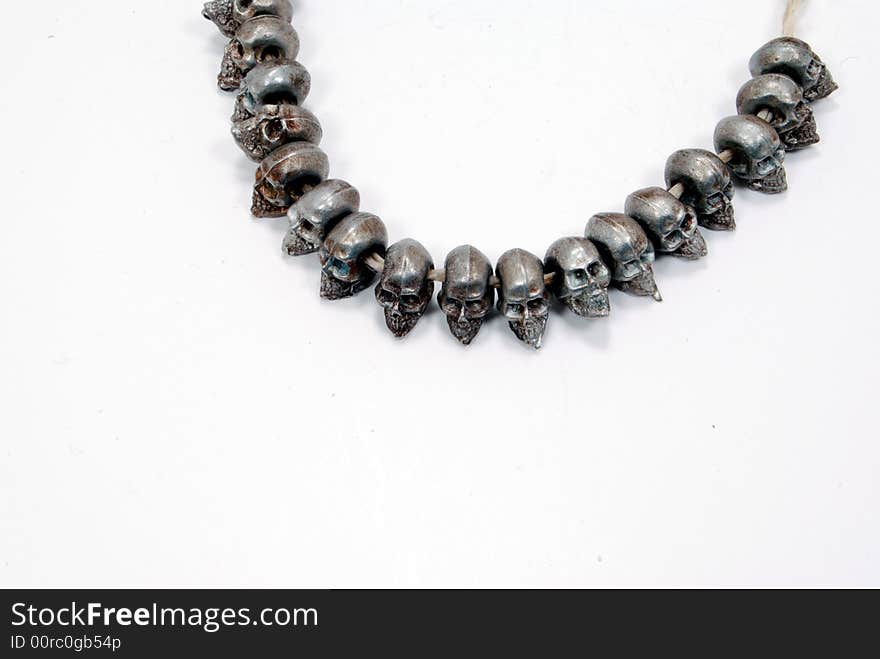 Dye cast pewter figurine skulls, beads on string. Dye cast pewter figurine skulls, beads on string