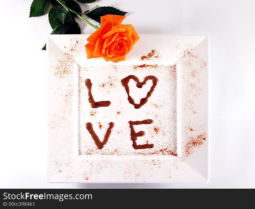 Love in chocolate on white plate with rose. Love in chocolate on white plate with rose.