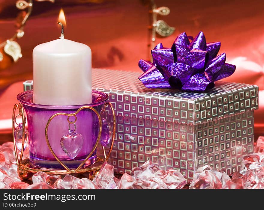 Violet candle with heart and gift box