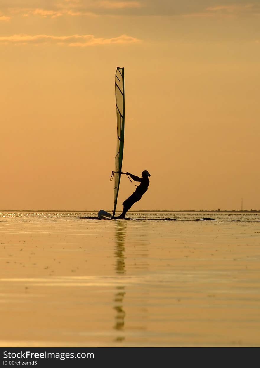 Silhouette Of A Wind-surfer On A Sunset 1