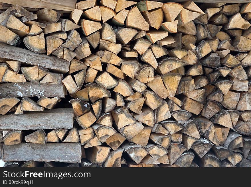 Photo of stacked firewood in storage until winter. Photo of stacked firewood in storage until winter.