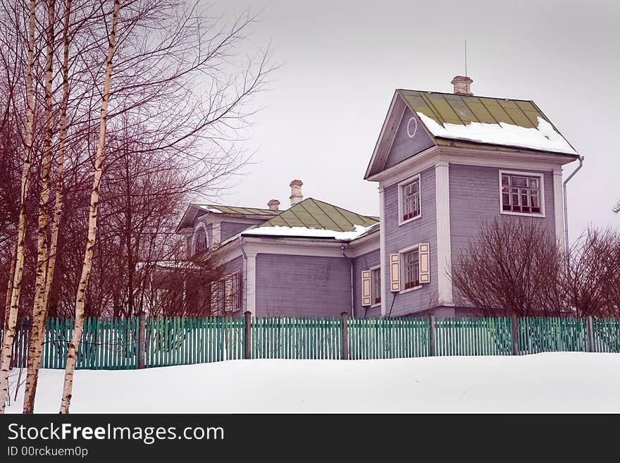 The big rural house in cloudy winter day