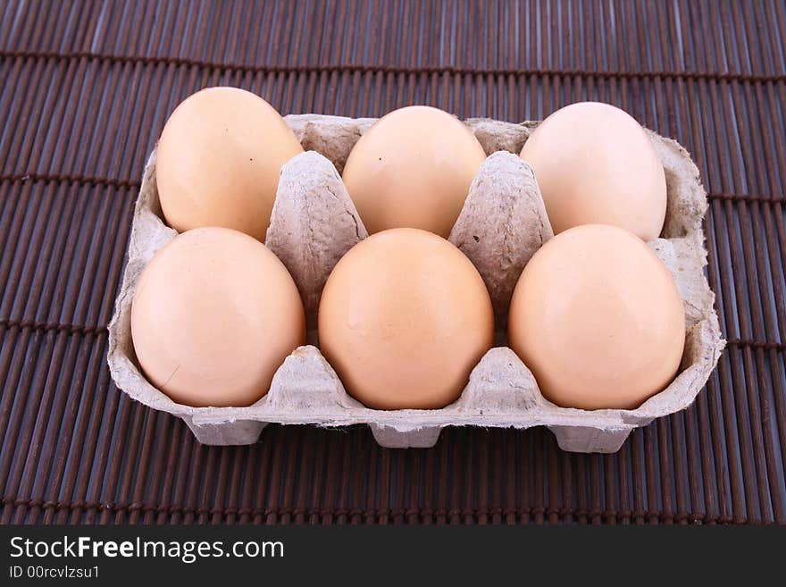 Brown eggs against a bright white background