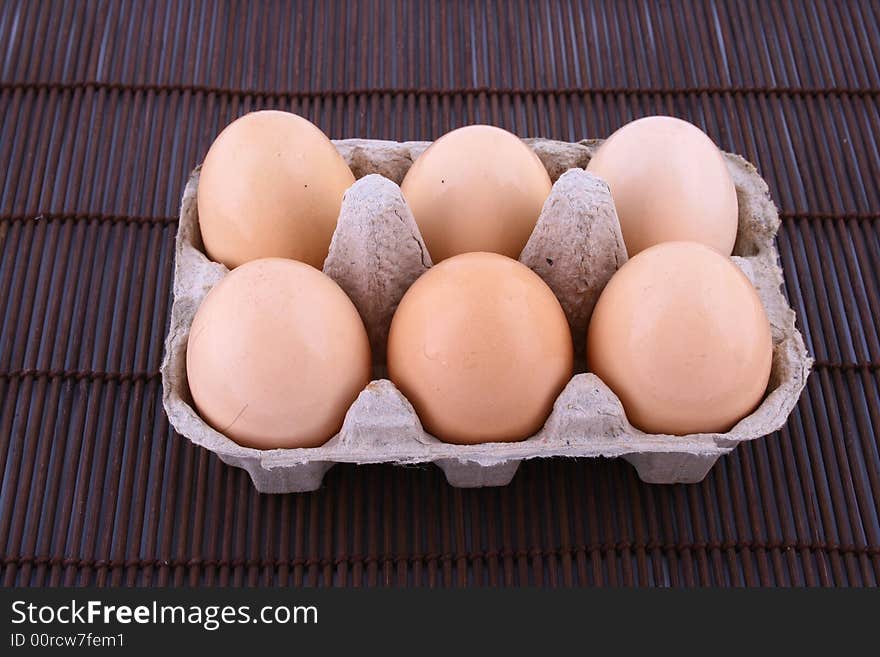 Brown eggs against a bright white background