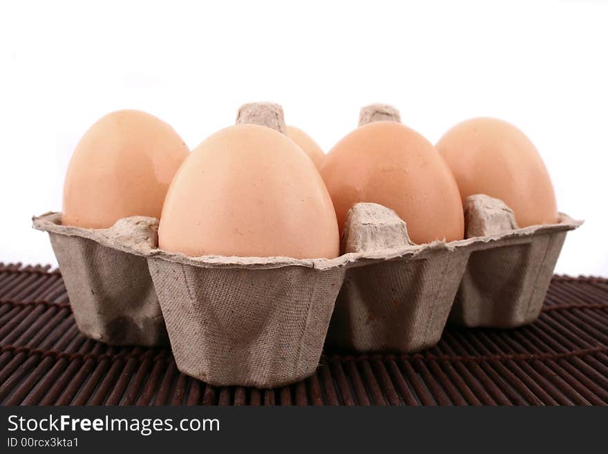 Brown eggs against a bright white background