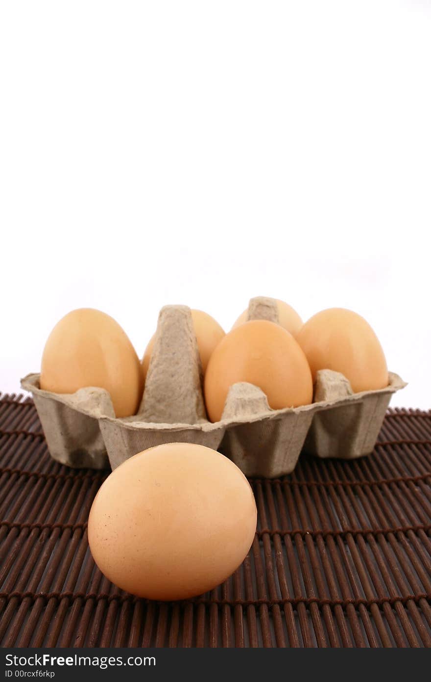 Brown eggs against a bright white background