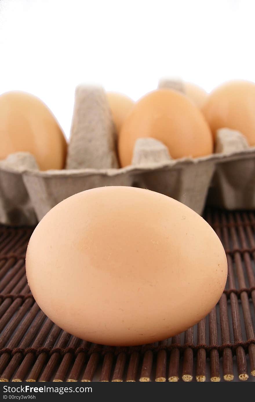 Brown eggs against a bright white background